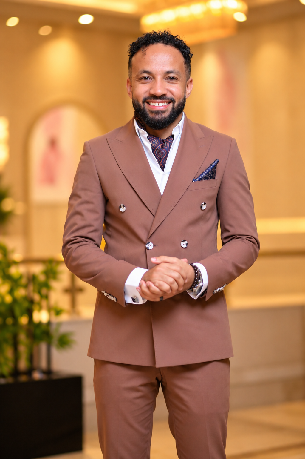 Dr. Mohanad Ali in an elegant brown suit